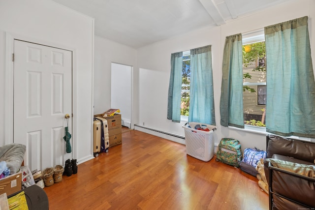 60 Albert St, Torrington, CT 06790 - living area with wood finished floors, a baseboard radiator, and a baseboard heating unit