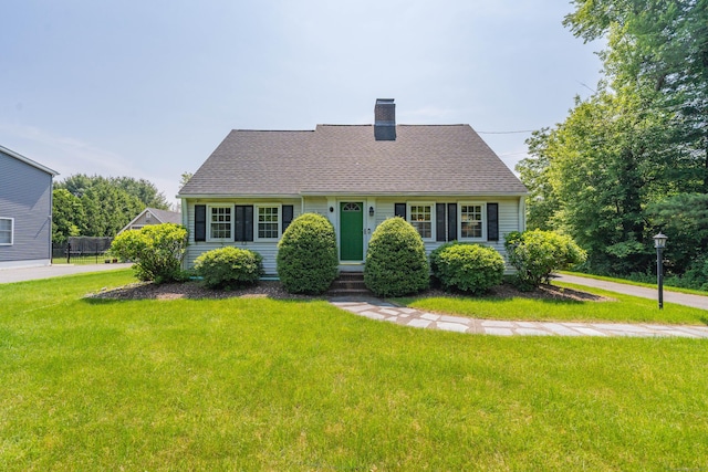 52 N Grand St, Suffield, CT 06093 - new england style home featuring a chimney, a front yard, entry steps, and roof with shingles