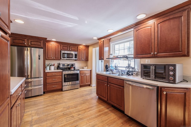 52 N Grand St, Suffield, CT 06093 - kitchen with appliances with stainless steel finishes, a sink, recessed lighting, light countertops, and light wood finished floors