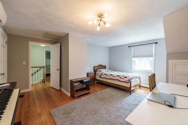 52 N Grand St, Suffield, CT 06093 - bedroom featuring hardwood / wood-style floors, a baseboard heating unit, baseboards, and attic access