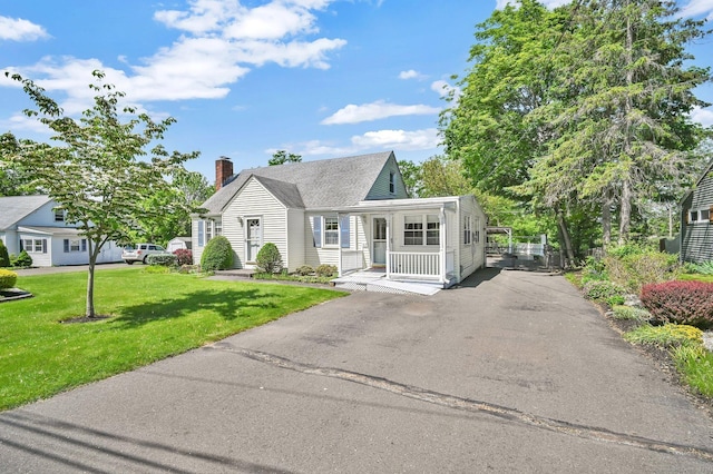 23 Charter Rd, Ellington, CT 06029 - view of front of property featuring asphalt driveway, a chimney, and a front lawn