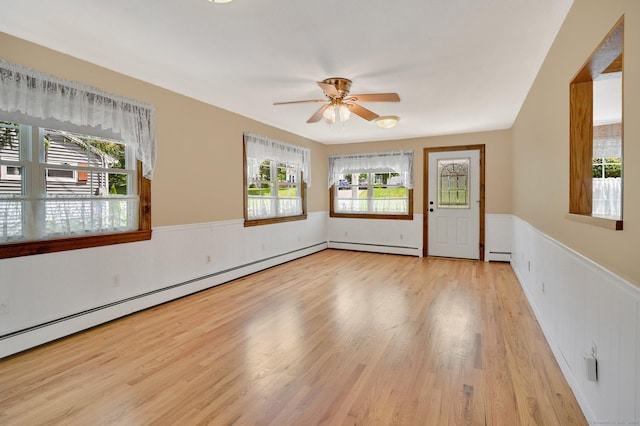 23 Charter Rd, Ellington, CT 06029 - empty room featuring a wainscoted wall, ceiling fan, light wood-style floors, and baseboard heating