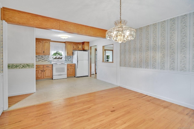 23 Charter Rd, Ellington, CT 06029 - kitchen with white appliances, a chandelier, wainscoting, light wood-type flooring, and light countertops