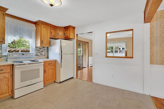 23 Charter Rd, Ellington, CT 06029 - kitchen featuring white appliances, light floors, light countertops, brown cabinets, and decorative backsplash