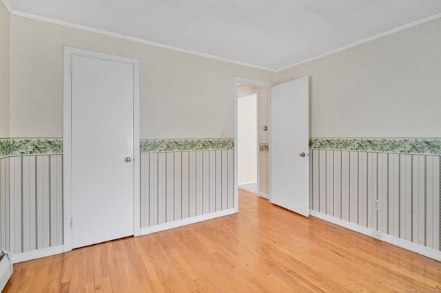 23 Charter Rd, Ellington, CT 06029 - unfurnished room with wood finished floors, a wainscoted wall, crown molding, wallpapered walls, and a baseboard radiator