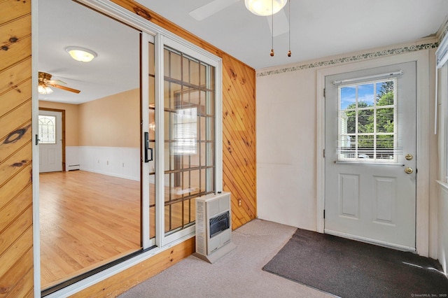 23 Charter Rd, Ellington, CT 06029 - doorway to outside featuring ceiling fan, heating unit, baseboard heating, and wood walls