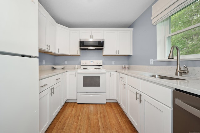 30 Seymour Rd Apt D3, Plymouth, CT 06786 - kitchen with stainless steel appliances, light countertops, white cabinets, and light wood-type flooring