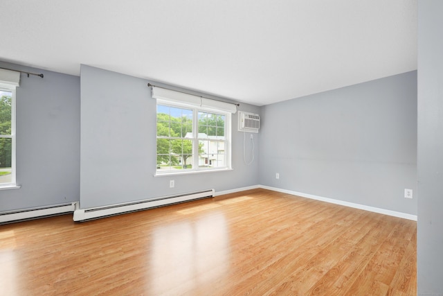 30 Seymour Rd Apt D3, Plymouth, CT 06786 - spare room featuring a wall mounted AC, wood finished floors, and a baseboard radiator