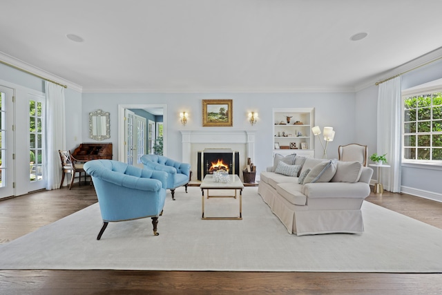 66 Stanton Rd, Darien, CT 06820 - living room featuring ornamental molding, a warm lit fireplace, and wood finished floors