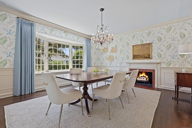 66 Stanton Rd, Darien, CT 06820 - dining space featuring wallpapered walls, dark wood finished floors, ornamental molding, a wainscoted wall, and a chandelier