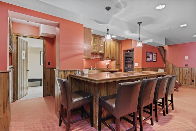 66 Stanton Rd, Darien, CT 06820 - indoor wet bar featuring light carpet, wainscoting, wooden walls, pendant lighting, and recessed lighting