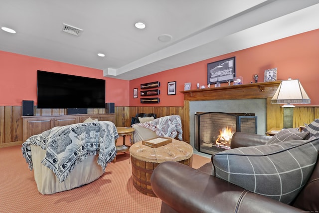 66 Stanton Rd, Darien, CT 06820 - carpeted living room with a warm lit fireplace, a wainscoted wall, and recessed lighting