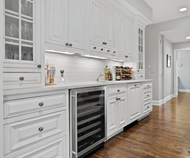 66 Stanton Rd, Darien, CT 06820 - indoor wet bar with beverage cooler, backsplash, dark wood-style floors, and recessed lighting