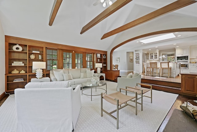 66 Stanton Rd, Darien, CT 06820 - living area with arched walkways, beamed ceiling, recessed lighting, built in shelves, and ceiling fan