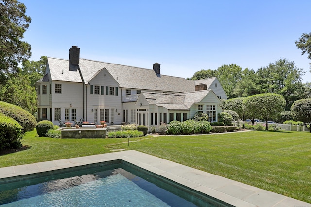66 Stanton Rd, Darien, CT 06820 - rear view of property with a yard, a patio, a chimney, and an outdoor pool