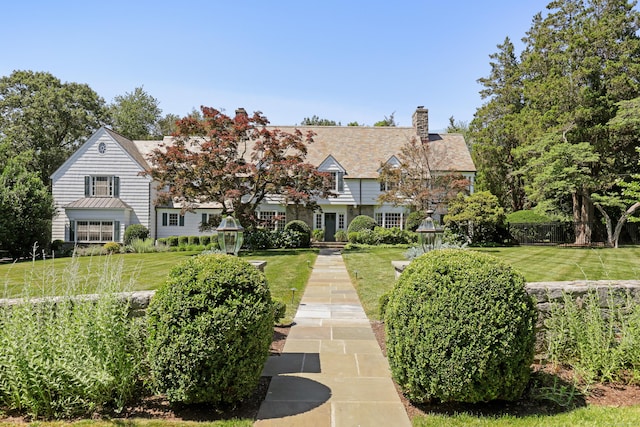 66 Stanton Rd, Darien, CT 06820 - view of front facade featuring a front yard and a chimney