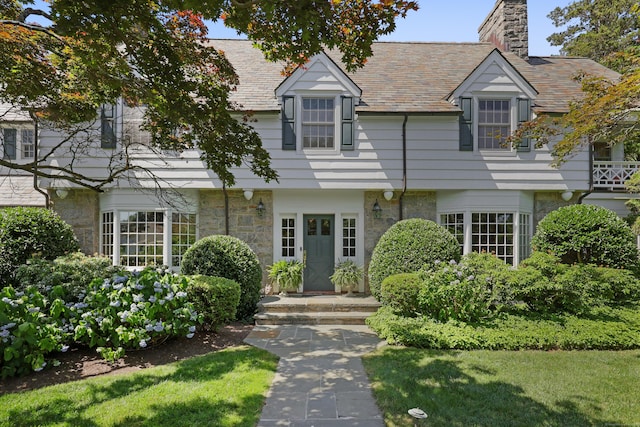 66 Stanton Rd, Darien, CT 06820 - view of front facade featuring stone siding, a chimney, and a high end roof
