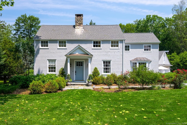 3 Bittersweet Trl, Norwalk, CT 06853 - colonial-style house featuring a front lawn, a chimney, and roof with shingles