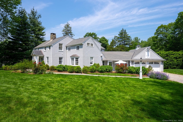 3 Bittersweet Trl, Norwalk, CT 06853 - colonial inspired home featuring a front lawn, a chimney, an attached garage, and driveway