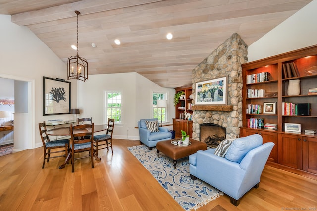 3 Bittersweet Trl, Norwalk, CT 06853 - living area featuring lofted ceiling, light wood-style floors, a fireplace, a chandelier, and baseboards