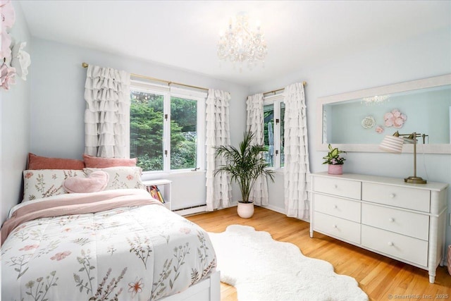 10 Fernbrook Dr, Brookfield, CT 06804 - bedroom with light wood-style floors, a baseboard radiator, and a chandelier