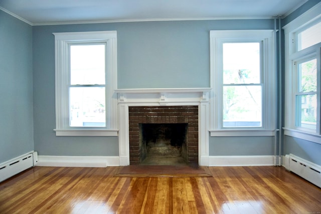 10 Fleming St, Waterbury, CT 06710 - unfurnished living room featuring a baseboard heating unit, hardwood / wood-style flooring, crown molding, a brick fireplace, and baseboards
