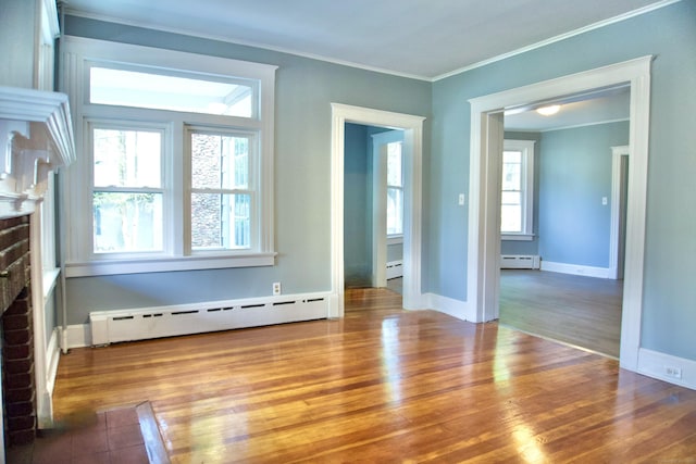 10 Fleming St, Waterbury, CT 06710 - unfurnished living room featuring a baseboard radiator, a fireplace, wood finished floors, ornamental molding, and baseboards