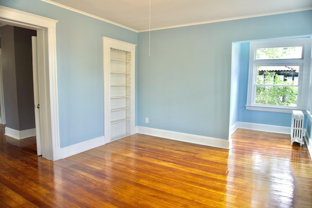 10 Fleming St, Waterbury, CT 06710 - empty room with hardwood / wood-style floors, radiator, ornamental molding, and baseboards