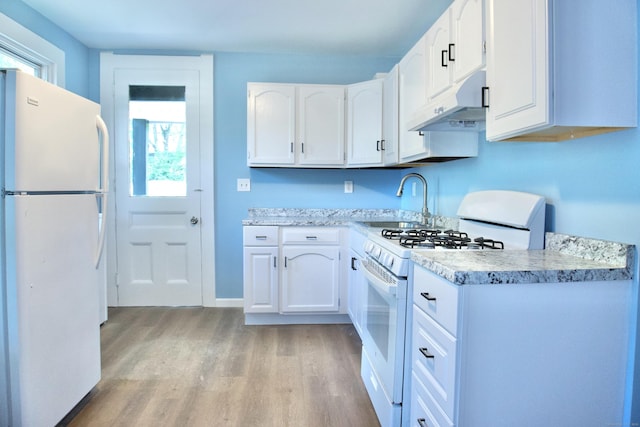 10 Fleming St, Waterbury, CT 06710 - kitchen featuring white appliances, under cabinet range hood, a sink, light wood-style flooring, and white cabinets