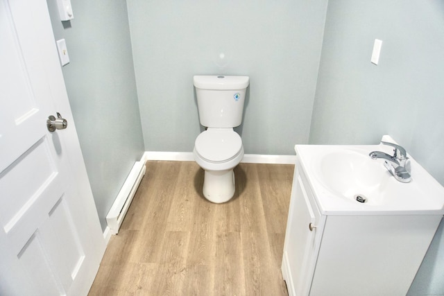 10 Fleming St, Waterbury, CT 06710 - half bathroom with wood finished floors, baseboard heating, vanity, toilet, and baseboards