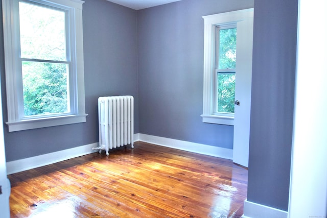 10 Fleming St, Waterbury, CT 06710 - unfurnished room with radiator heating unit, wood finished floors, and baseboards