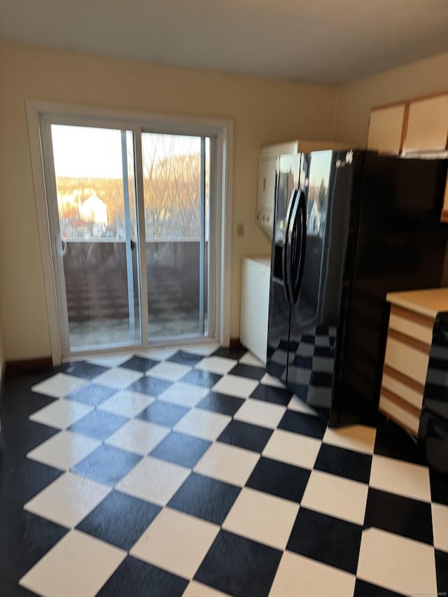 81 Chipman St Apt 6, Waterbury, CT 06708 - kitchen featuring tile patterned floors, black fridge with ice dispenser, and light countertops