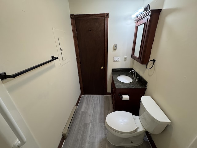 81 Chipman St Apt 6, Waterbury, CT 06708 - bathroom with baseboard heating, vanity, toilet, and wood finished floors