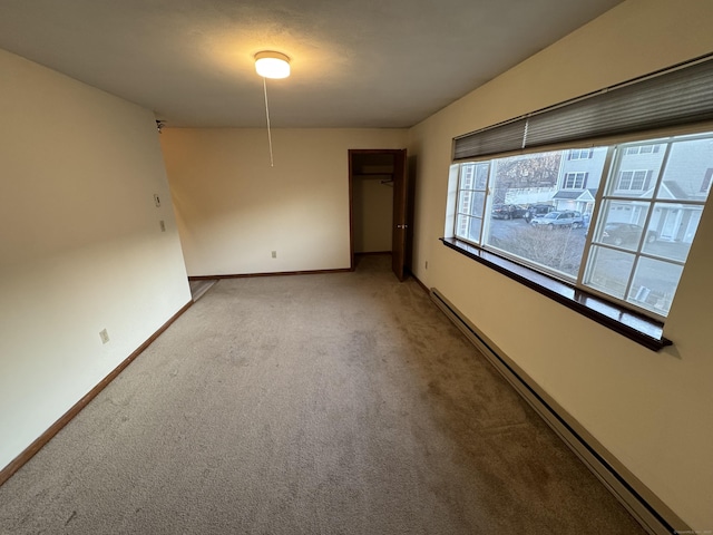 81 Chipman St Apt 6, Waterbury, CT 06708 - empty room featuring a baseboard heating unit, light carpet, and baseboards