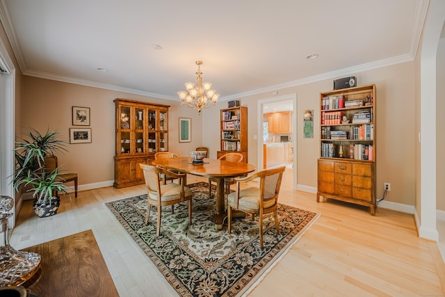 5 Stone Wall Ln, Woodbridge, CT 06525 - dining space featuring a chandelier, light wood-style flooring, ornamental molding, and baseboards