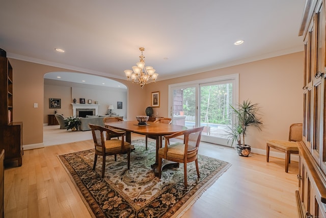 5 Stone Wall Ln, Woodbridge, CT 06525 - dining area with a fireplace, crown molding, light wood-type flooring, a chandelier, and recessed lighting