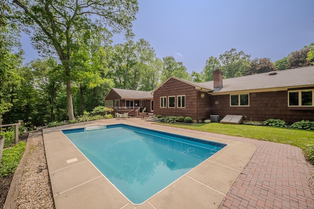 5 Stone Wall Ln, Woodbridge, CT 06525 - outdoor pool featuring a patio, view of scattered trees, and a lawn