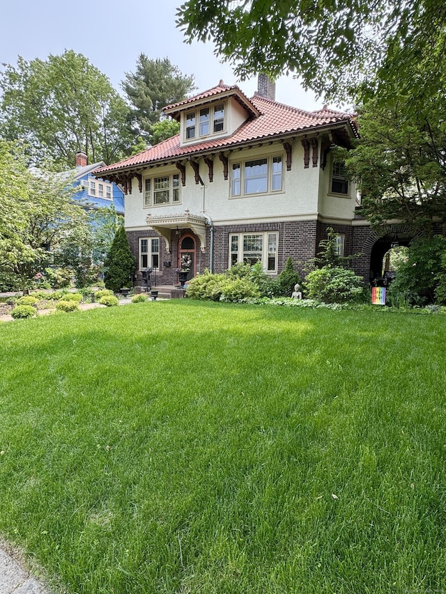 160 Kenyon St, Hartford, CT 06105 - mediterranean / spanish house featuring a chimney, stucco siding, and a front lawn