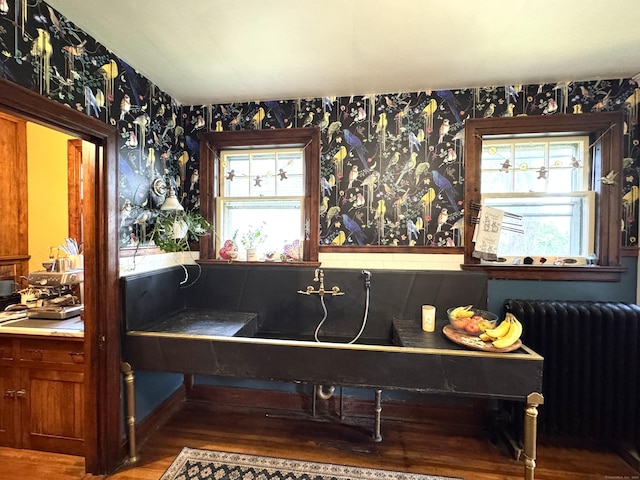 160 Kenyon St, Hartford, CT 06105 - detailed view of radiator, wallpapered walls, and wood finished floors
