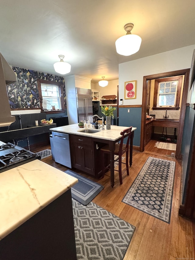 160 Kenyon St, Hartford, CT 06105 - kitchen featuring dishwasher, a sink, wood finished floors, a center island with sink, and dark brown cabinets