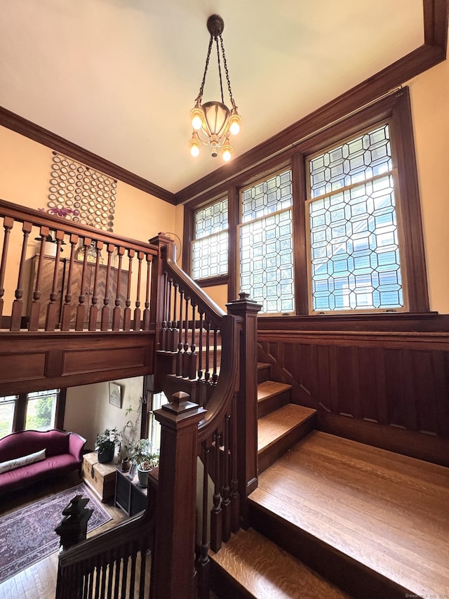160 Kenyon St, Hartford, CT 06105 - stairway featuring wood finished floors, ornamental molding, and a chandelier