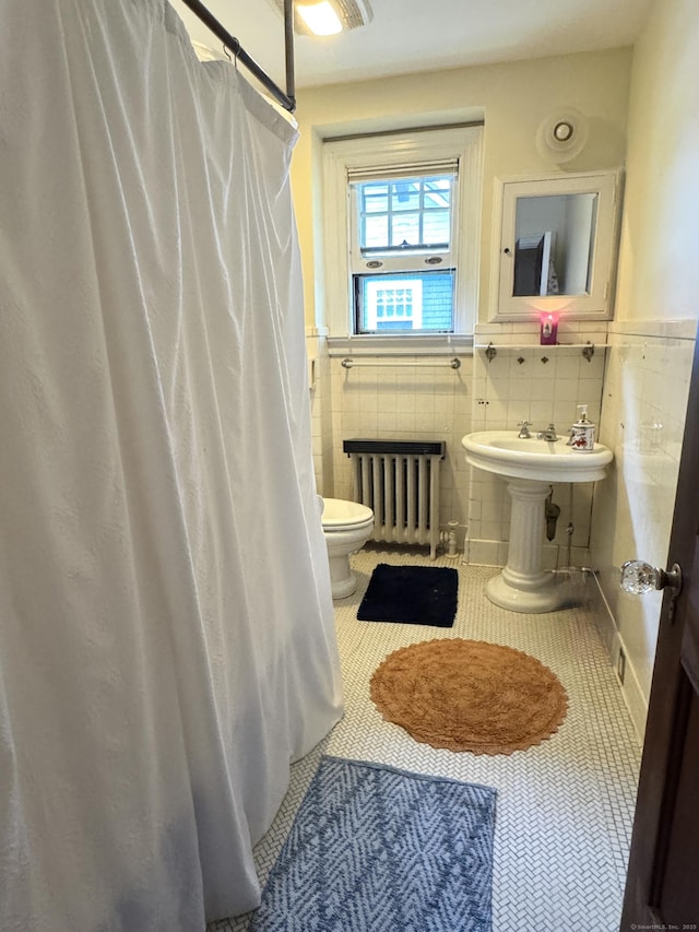 160 Kenyon St, Hartford, CT 06105 - full bathroom featuring radiator, tile patterned floors, toilet, tile walls, and wainscoting