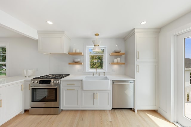 105 Blake Dr, Fairfield, CT 06824 - kitchen featuring stainless steel appliances, open shelves, a sink, light wood finished floors, and recessed lighting