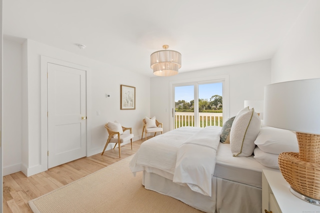 105 Blake Dr, Fairfield, CT 06824 - bedroom featuring access to exterior, light wood-style flooring, and baseboards