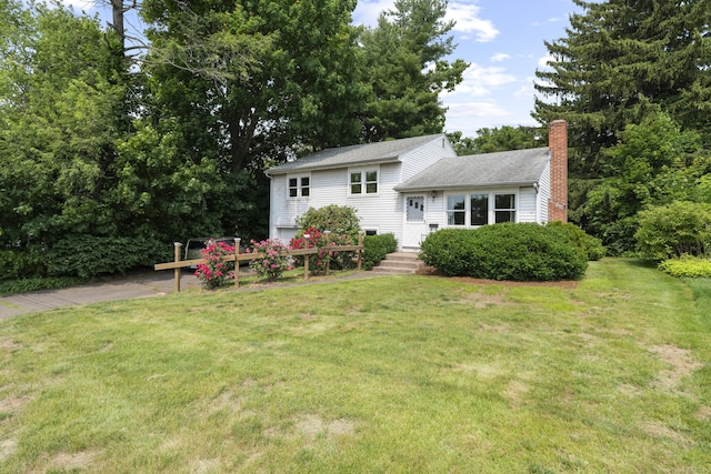 26 Caroldon Rd, Middletown, CT 06457 - tri-level home featuring a chimney, a front yard, roof with shingles, and driveway