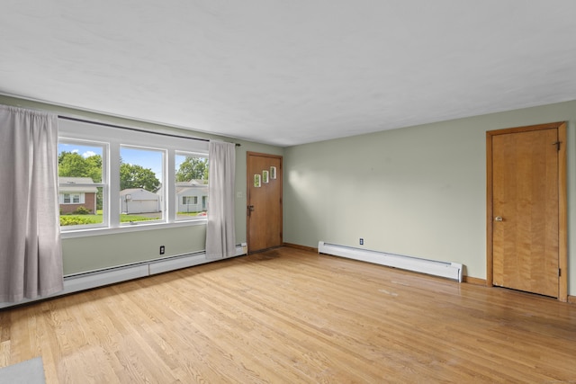 26 Caroldon Rd, Middletown, CT 06457 - empty room featuring a baseboard radiator, light wood-style flooring, and a baseboard heating unit