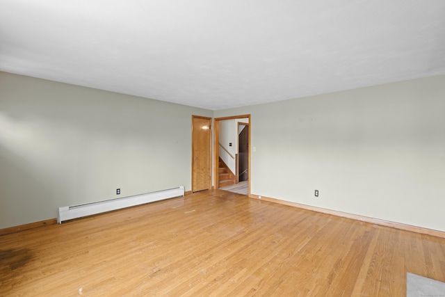 26 Caroldon Rd, Middletown, CT 06457 - empty room featuring baseboard heating, stairway, and light wood-type flooring
