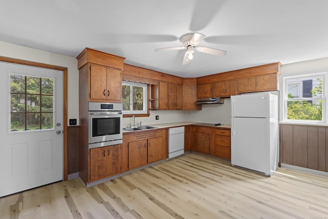 26 Caroldon Rd, Middletown, CT 06457 - kitchen with white appliances, under cabinet range hood, brown cabinets, and light wood-style flooring