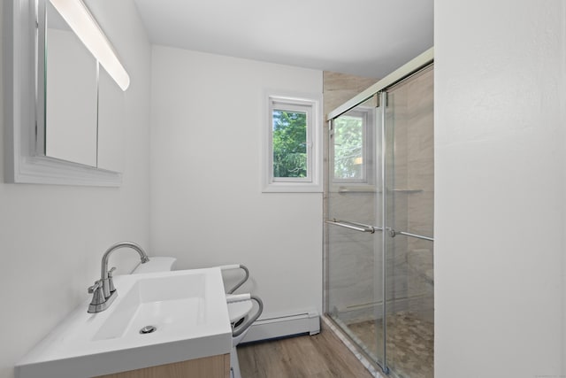 26 Caroldon Rd, Middletown, CT 06457 - bathroom featuring a baseboard heating unit, vanity, a stall shower, and wood finished floors
