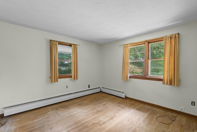 26 Caroldon Rd, Middletown, CT 06457 - unfurnished room with plenty of natural light, wood finished floors, and a baseboard radiator